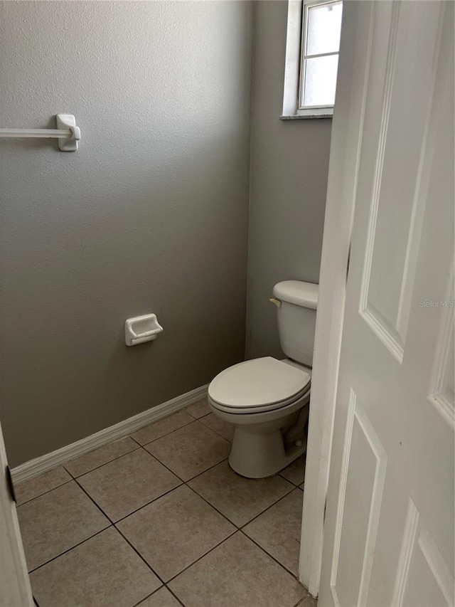 bathroom featuring toilet and tile patterned floors