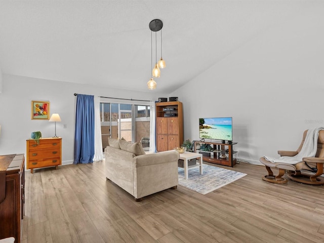 living room featuring high vaulted ceiling, light wood-style flooring, and baseboards