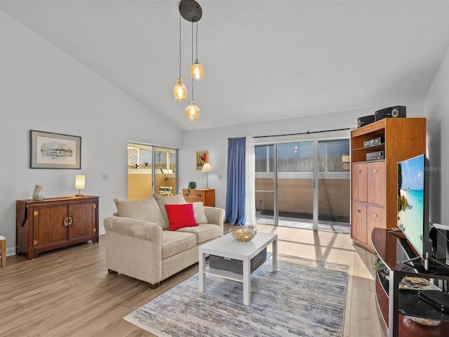 living room with light wood-style floors and lofted ceiling