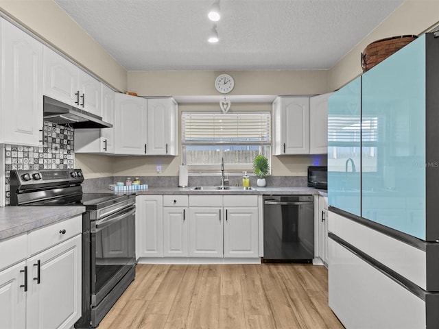 kitchen featuring stainless steel appliances, light wood-style flooring, white cabinetry, a sink, and under cabinet range hood