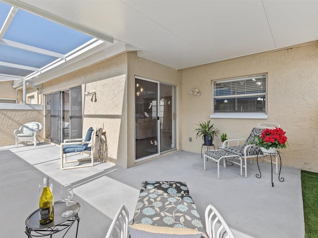 view of patio featuring a lanai