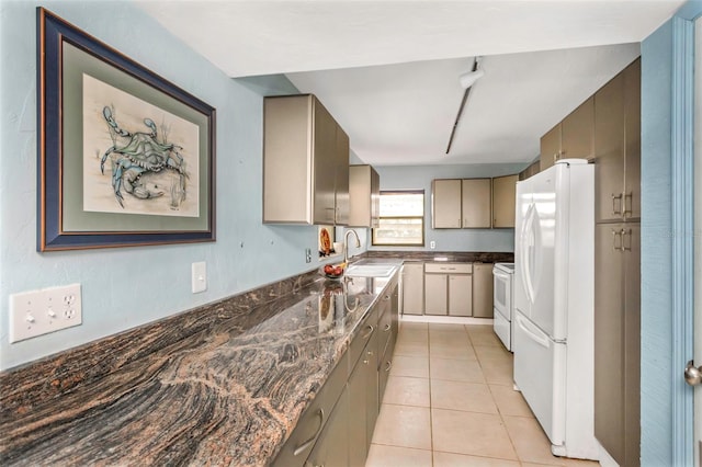 kitchen with white appliances, light tile patterned flooring, and sink