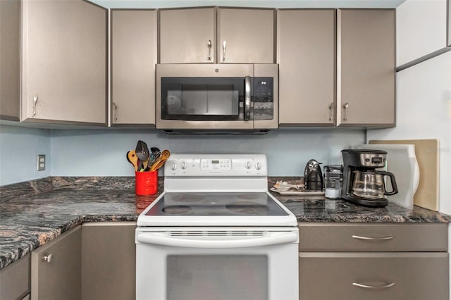 kitchen with dark stone counters and electric stove