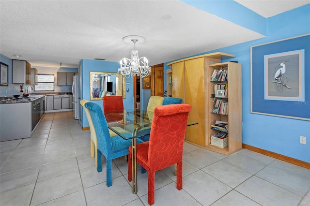 dining space featuring a textured ceiling, a chandelier, and light tile patterned floors