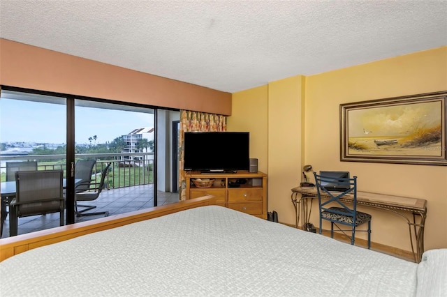 bedroom with access to outside and a textured ceiling