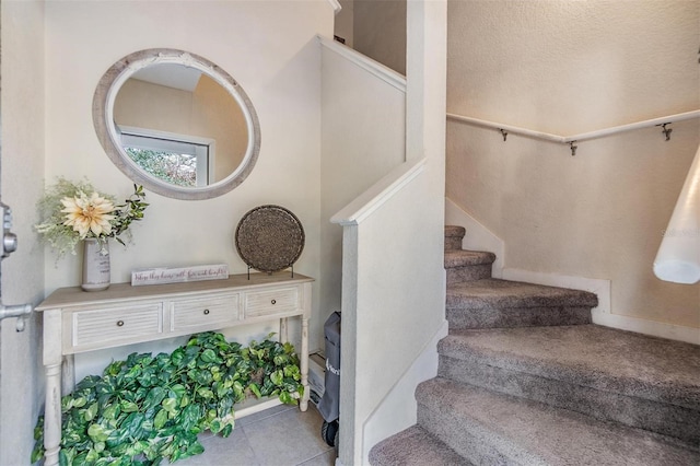 staircase with tile patterned floors