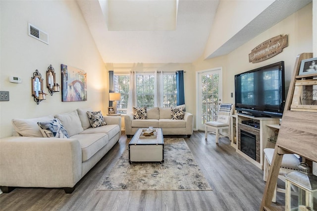 living room featuring hardwood / wood-style floors and high vaulted ceiling