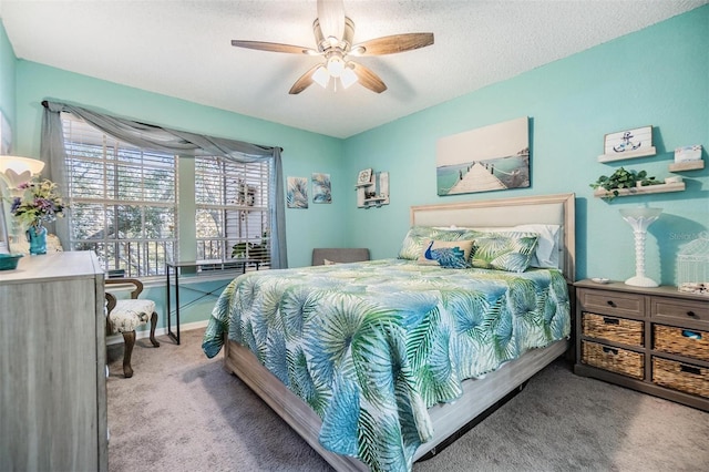 bedroom with ceiling fan, light carpet, and a textured ceiling