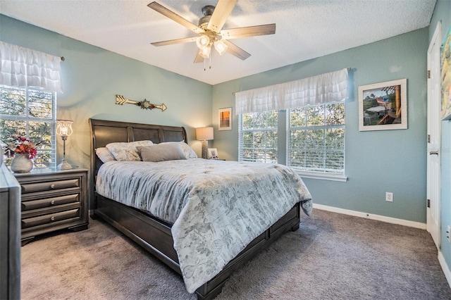 carpeted bedroom featuring a textured ceiling and ceiling fan