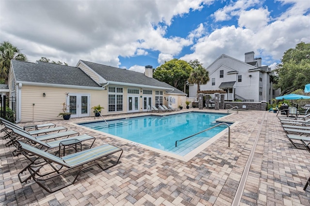 view of swimming pool with a pergola, french doors, and a patio