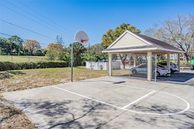 view of basketball court featuring a lawn