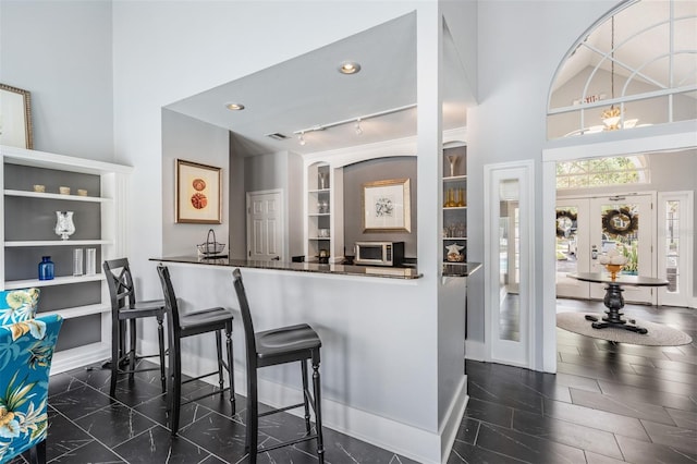 bar with french doors and built in features