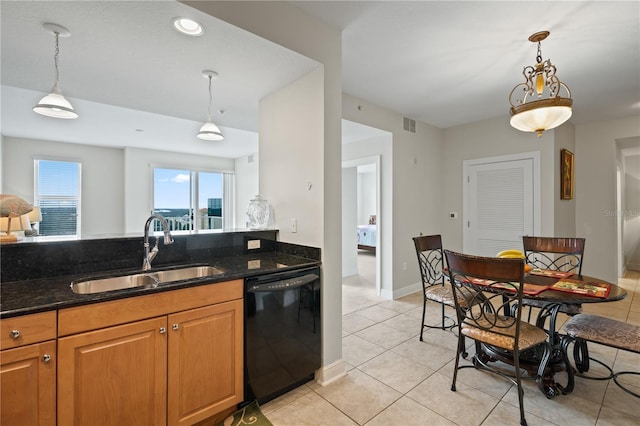 kitchen with sink, decorative light fixtures, dark stone counters, and black dishwasher