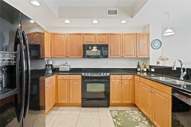 kitchen featuring black appliances, dark stone countertops, sink, hanging light fixtures, and light tile patterned floors