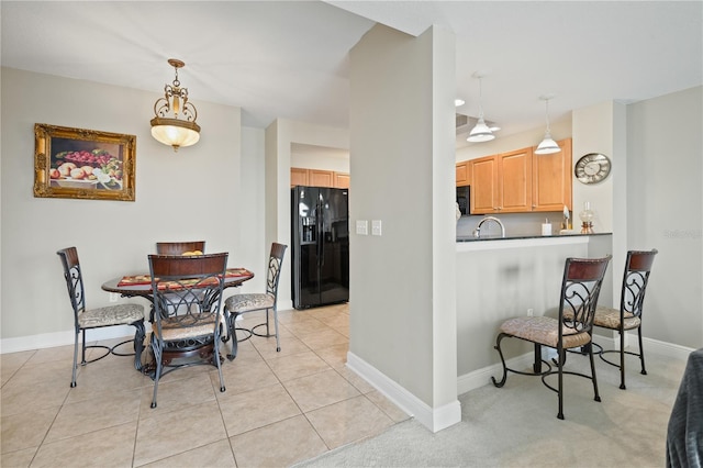 tiled dining room featuring sink