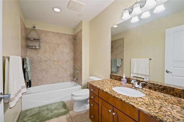 full bathroom featuring vanity, toilet, tiled shower / bath combo, and tile patterned flooring