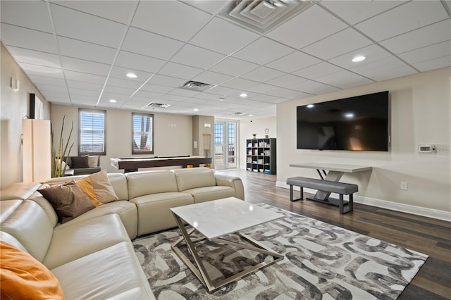 living room featuring dark hardwood / wood-style floors and a paneled ceiling