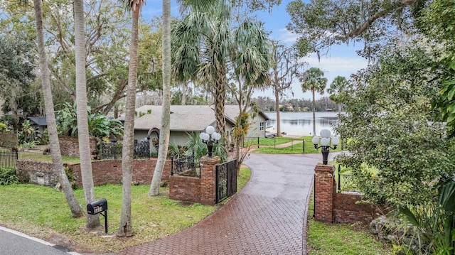 view of community featuring a yard and a water view