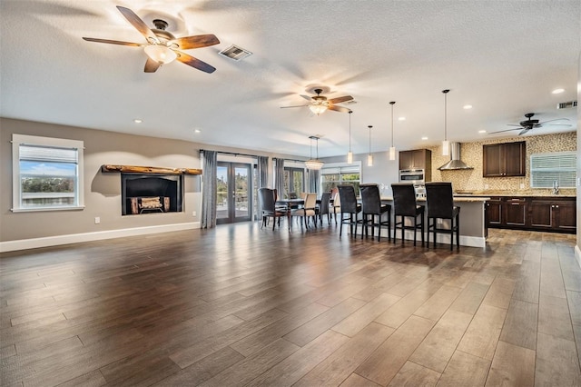 living room with dark hardwood / wood-style floors, a wealth of natural light, and sink