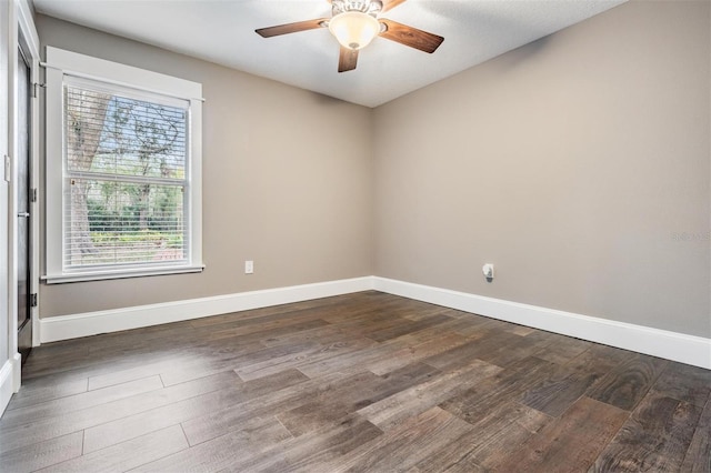 empty room with dark hardwood / wood-style flooring and ceiling fan