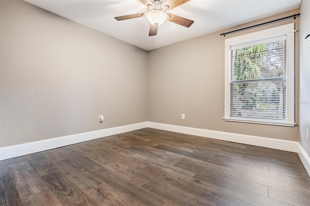 spare room featuring ceiling fan and dark wood-type flooring