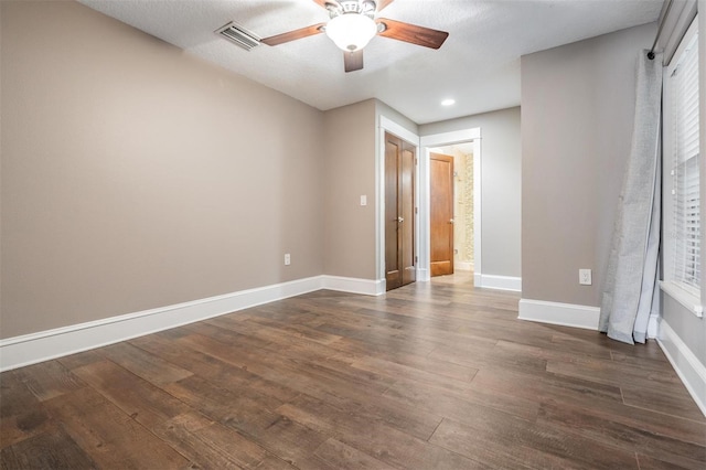 spare room featuring ceiling fan and dark hardwood / wood-style flooring