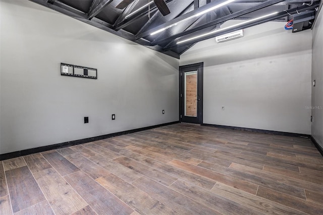 unfurnished room with vaulted ceiling