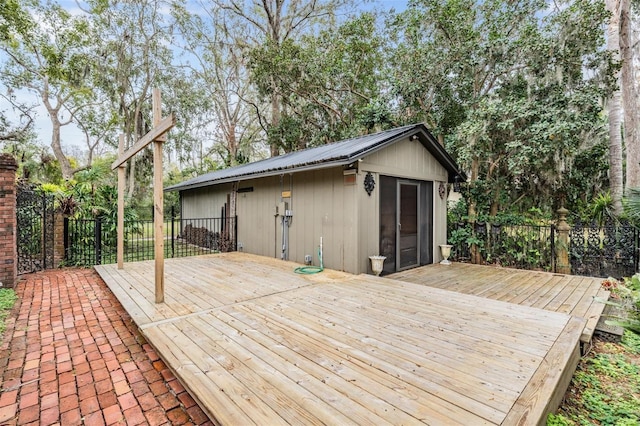 wooden terrace featuring an outdoor structure