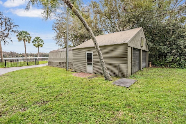 view of outbuilding with a garage and a lawn