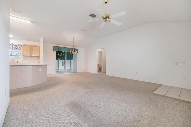 unfurnished living room featuring light carpet, lofted ceiling, and ceiling fan with notable chandelier