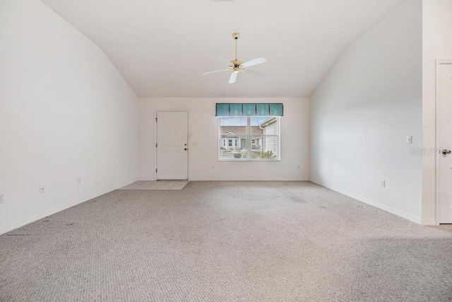 carpeted spare room with ceiling fan and lofted ceiling