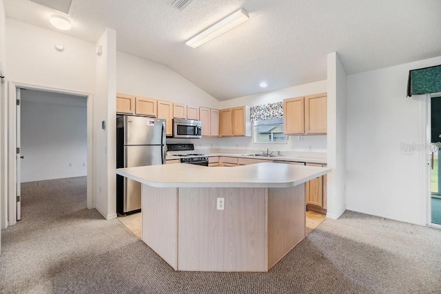 kitchen featuring light brown cabinetry, sink, a center island, and stainless steel appliances