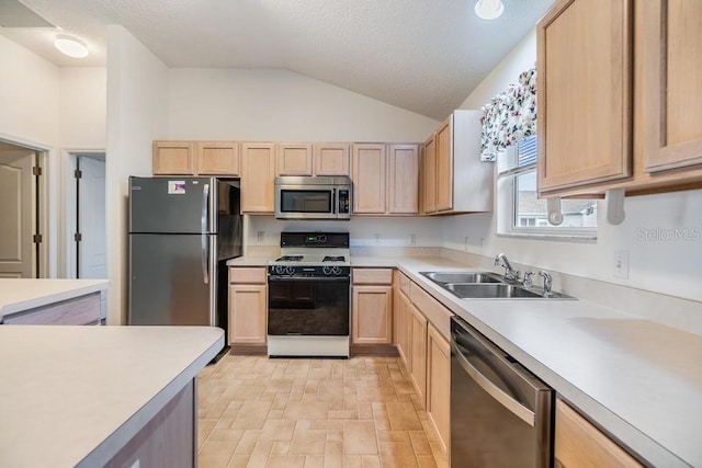 kitchen featuring appliances with stainless steel finishes, sink, and light brown cabinets