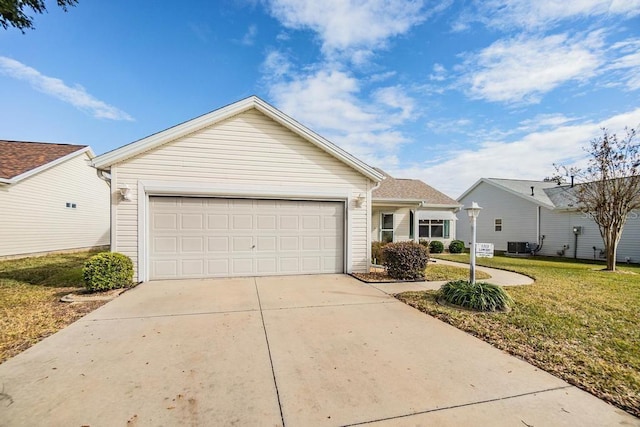 single story home with a garage and a front lawn