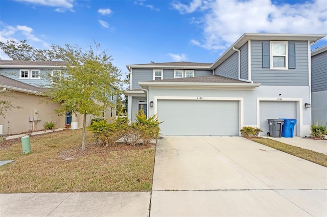 view of front of home with a garage and a front lawn