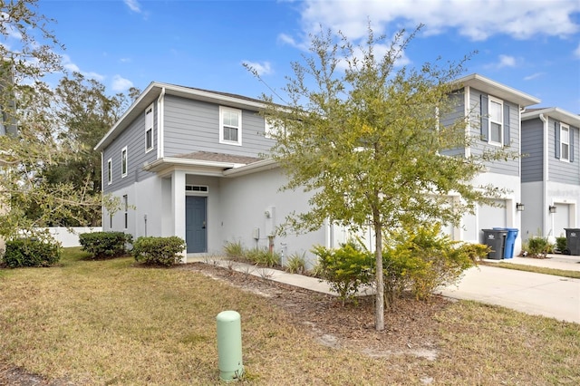 view of front facade with a front yard and a garage