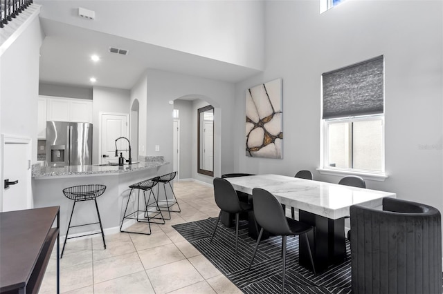 dining room with sink and light tile patterned flooring