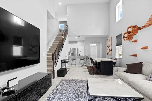 living room featuring a high ceiling and light tile patterned floors