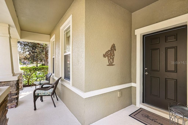 property entrance featuring a porch