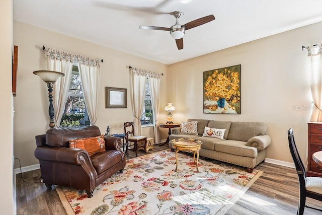 living room with ceiling fan and dark hardwood / wood-style flooring