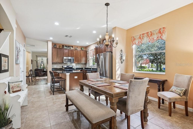 tiled dining area with a notable chandelier