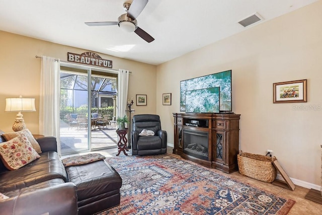 living room featuring ceiling fan and tile patterned flooring