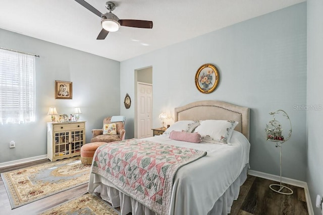 bedroom with ceiling fan and dark hardwood / wood-style floors