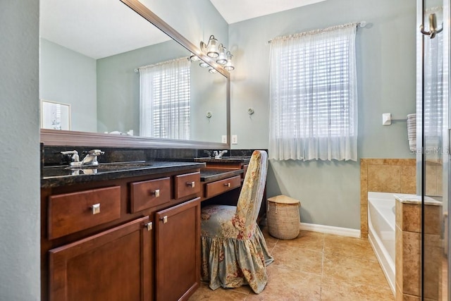 bathroom featuring a bathing tub, tile patterned flooring, and vanity