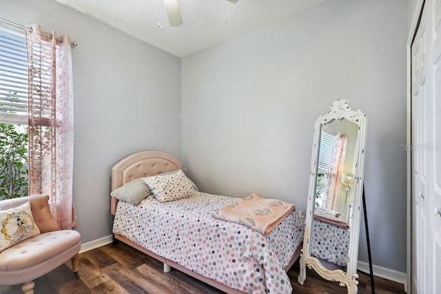 bedroom with ceiling fan and dark hardwood / wood-style flooring