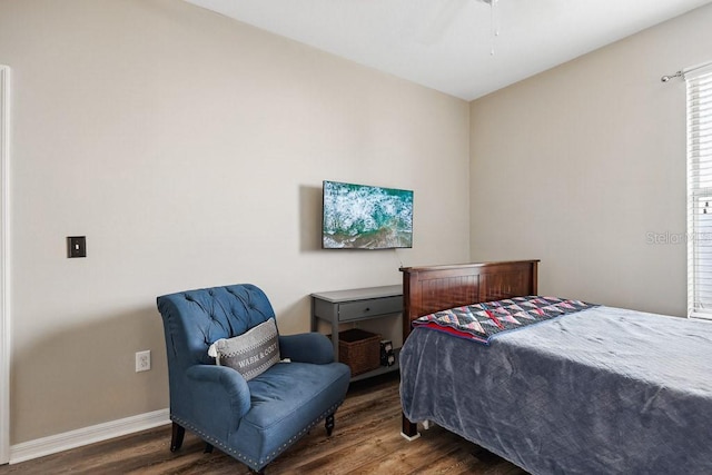 bedroom with ceiling fan and dark hardwood / wood-style floors