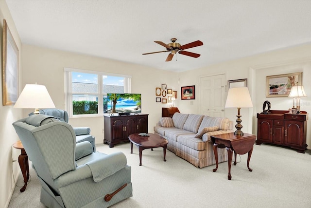 carpeted living room featuring ceiling fan