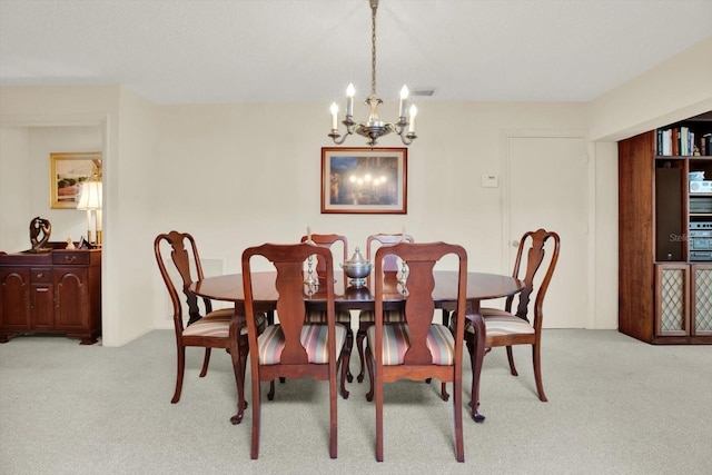 carpeted dining area with a chandelier