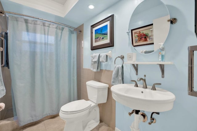 bathroom featuring curtained shower, tile patterned floors, sink, tile walls, and toilet