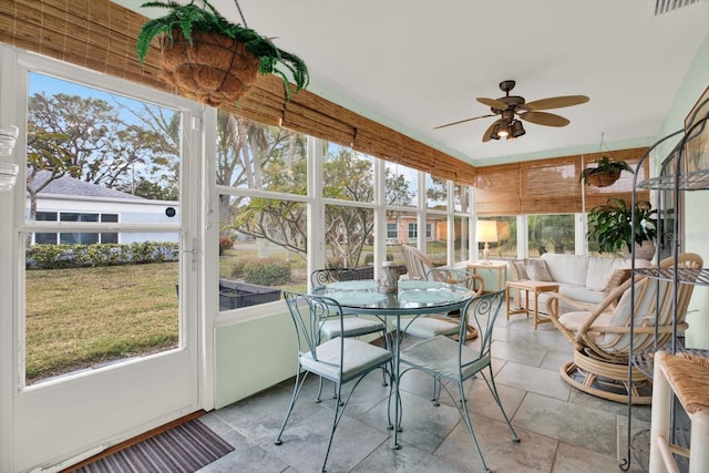 sunroom with ceiling fan